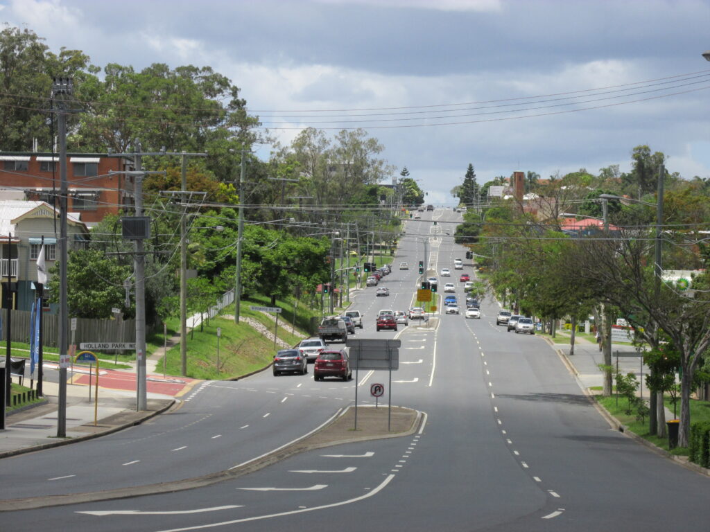 Holland Park residential street with Queenslander homes and tree-lined roads in Brisbane's inner south